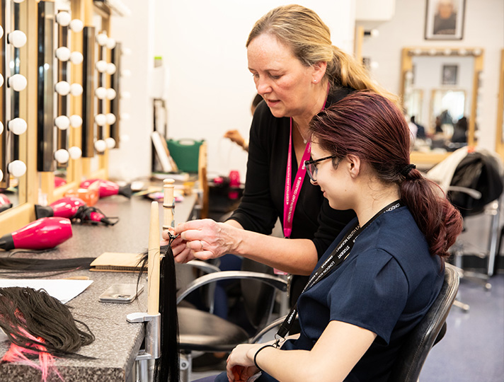 Student practising and styling hair