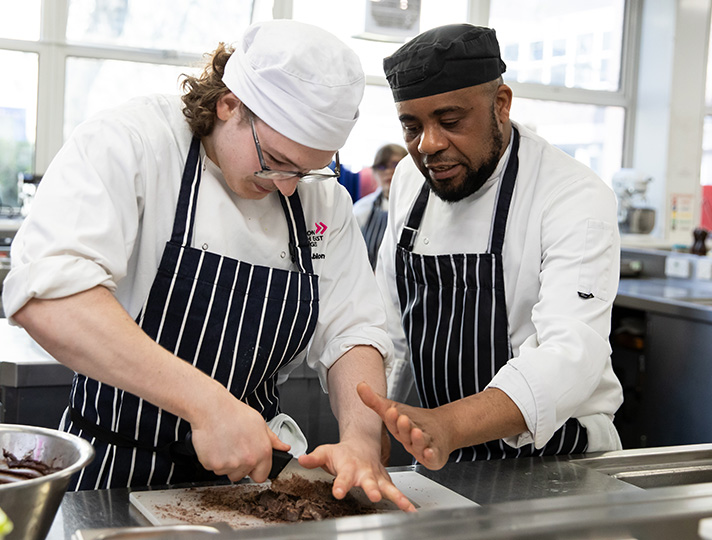 Student learning in kitchen